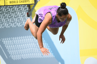 A contestant jumping off the Manu World Champs platform, mid-manu